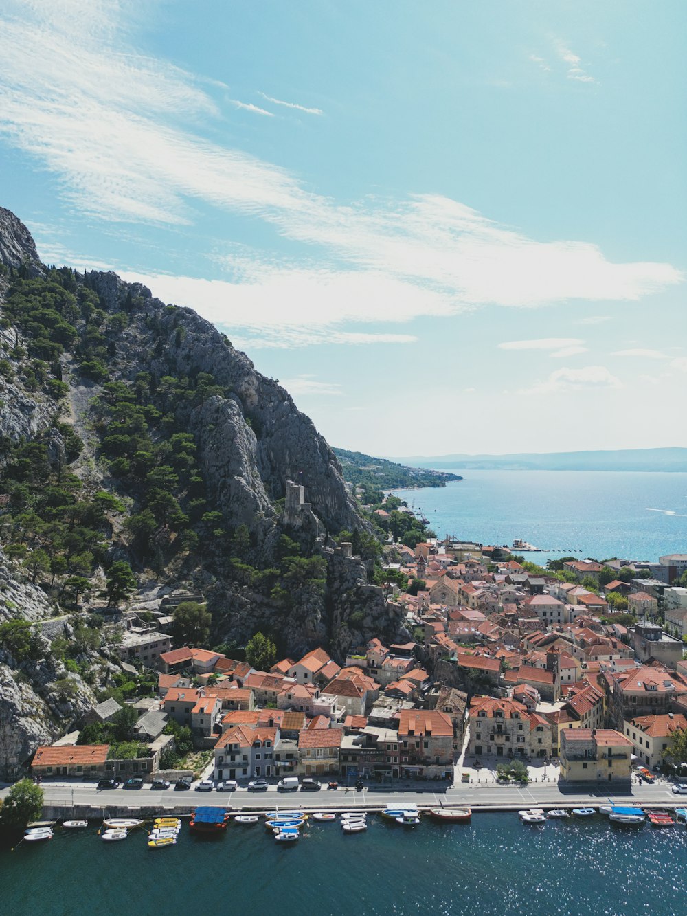 an aerial view of a small town on a cliff