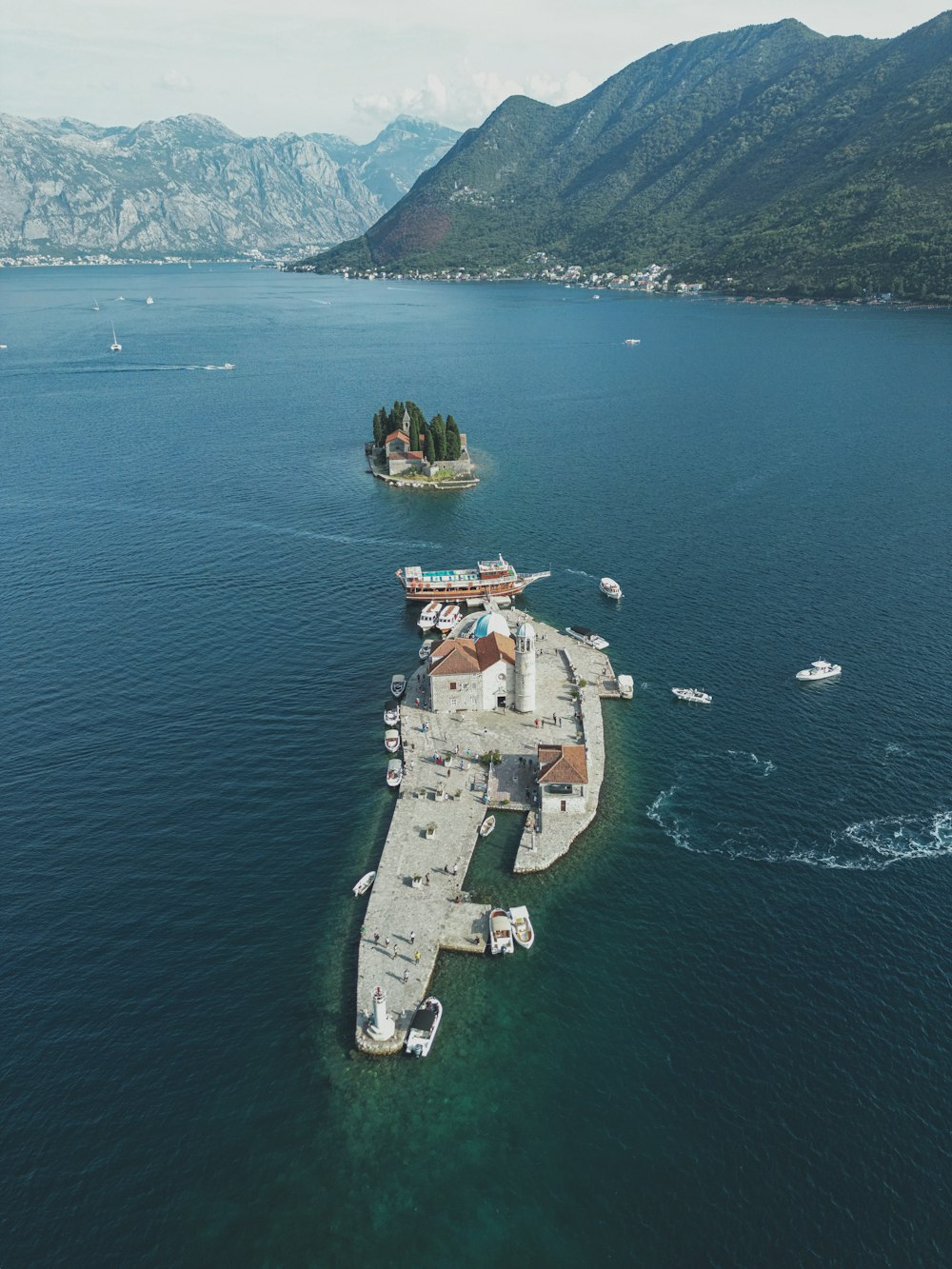 a large body of water with a small island in the middle of it