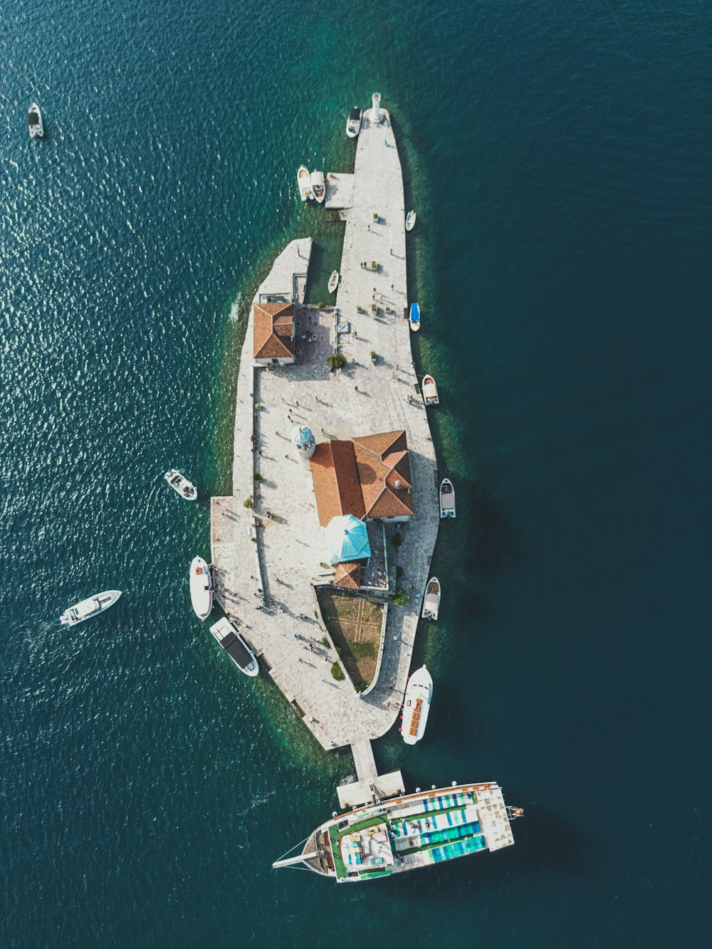 an aerial view of a pier in the middle of the ocean