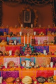 A colorful altar decorated with marigolds and candles.