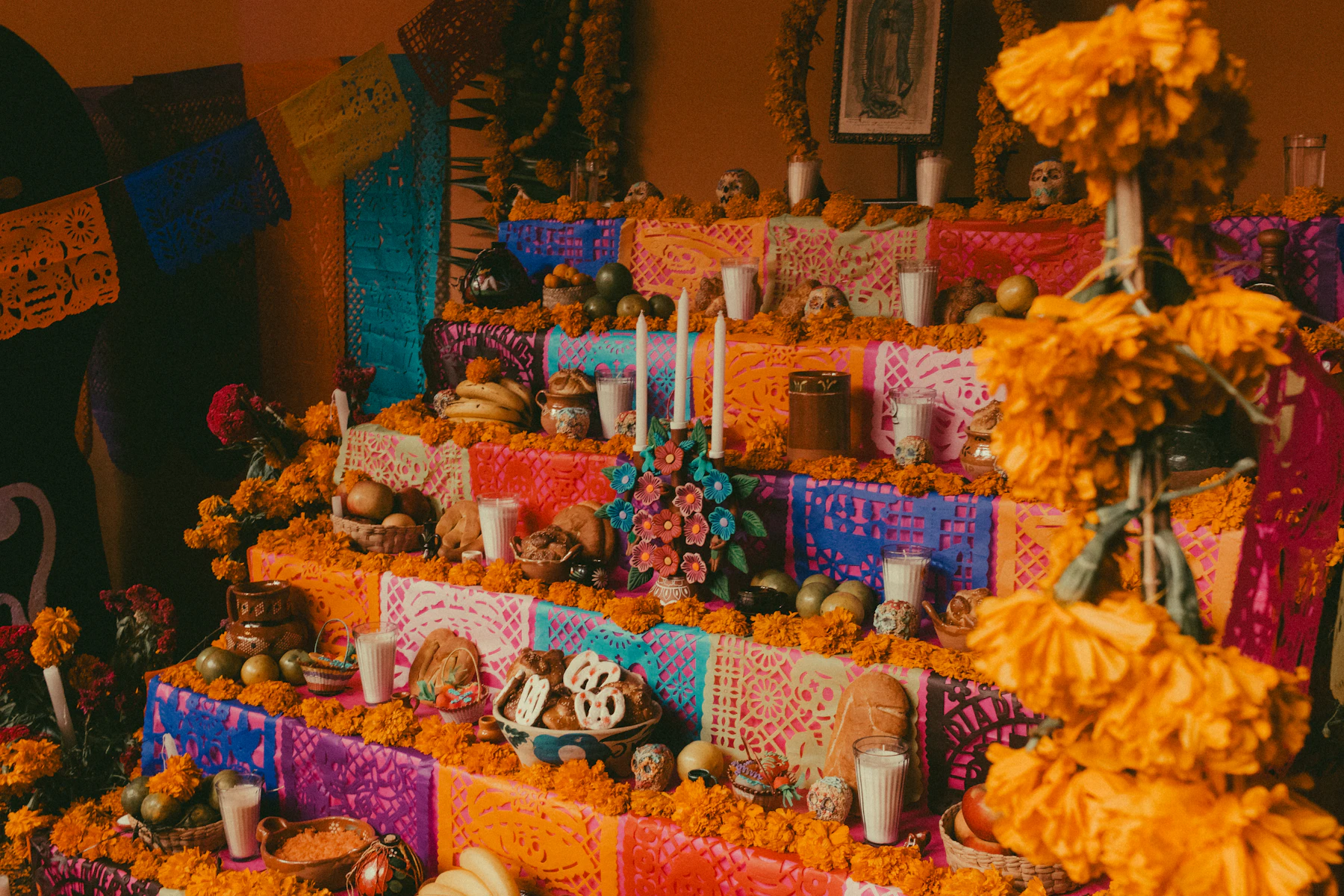 Día de Muertos altar with candles, sugar skulls and marigolds