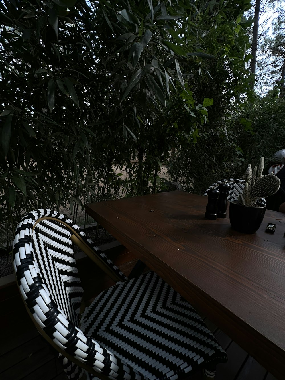 a wooden table topped with a black and white chair