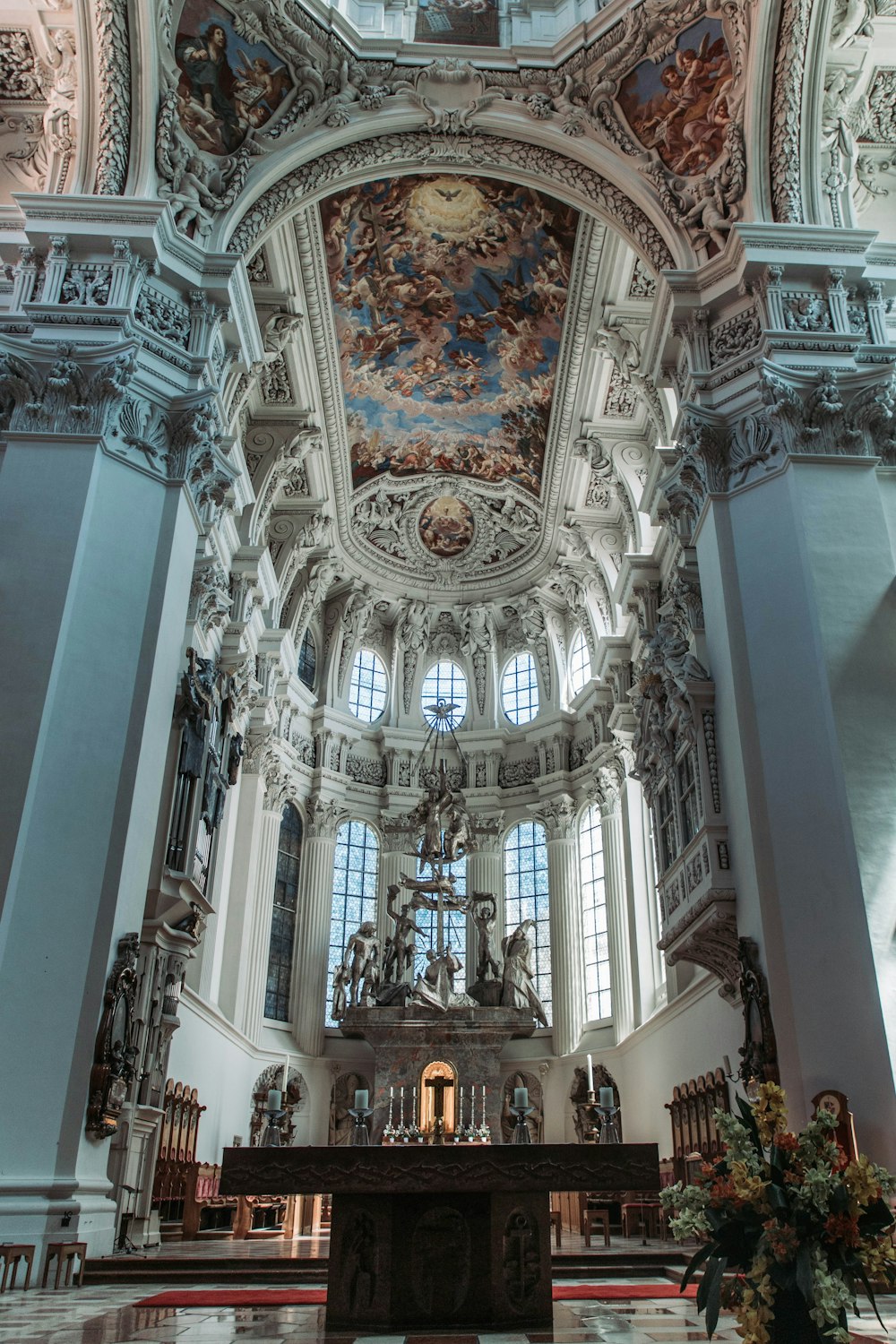 a church with a high vaulted ceiling and stained glass windows