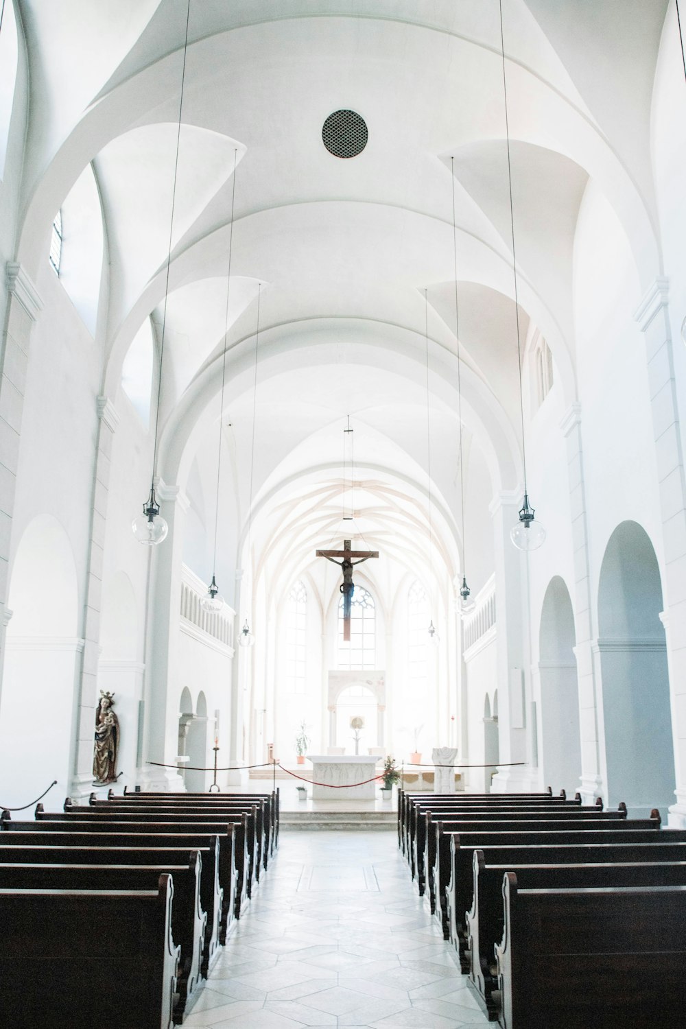 an empty church with pews and a cross