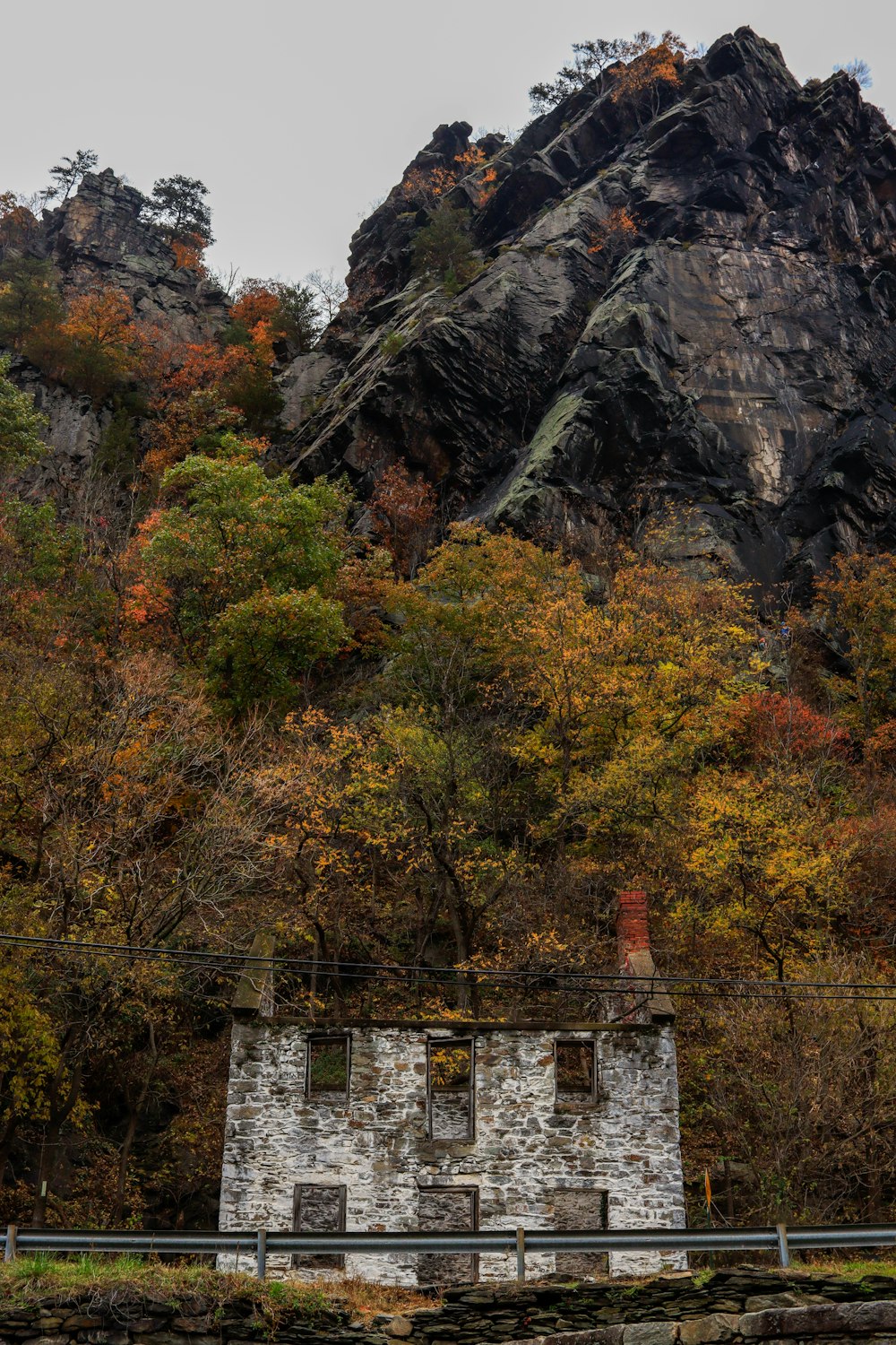 a stone building in front of a mountain