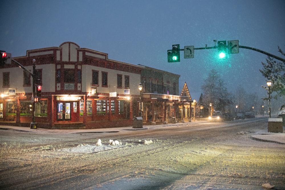 a green traffic light on a snowy street