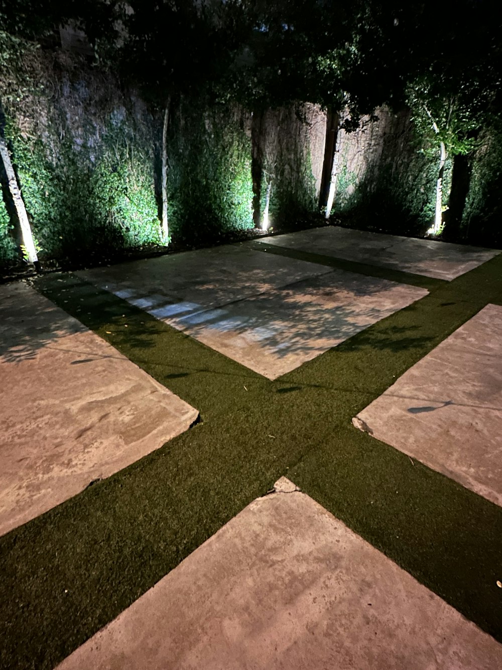 an outdoor area with artificial grass and lights