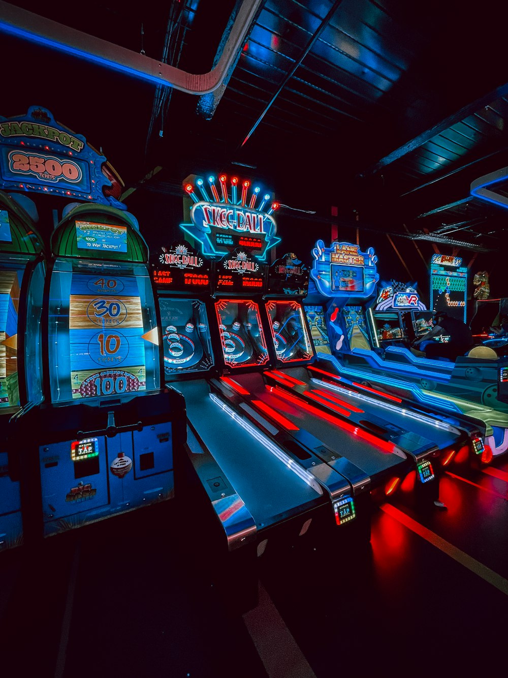 a row of arcade machines in a dark room