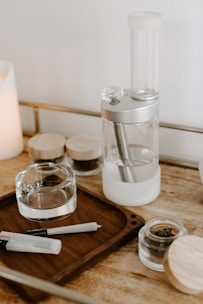 A vibrant collection of glass pipes and rolling trays arranged neatly on a rustic table.