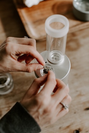 Hands carefully packing herbal medicine capsules.