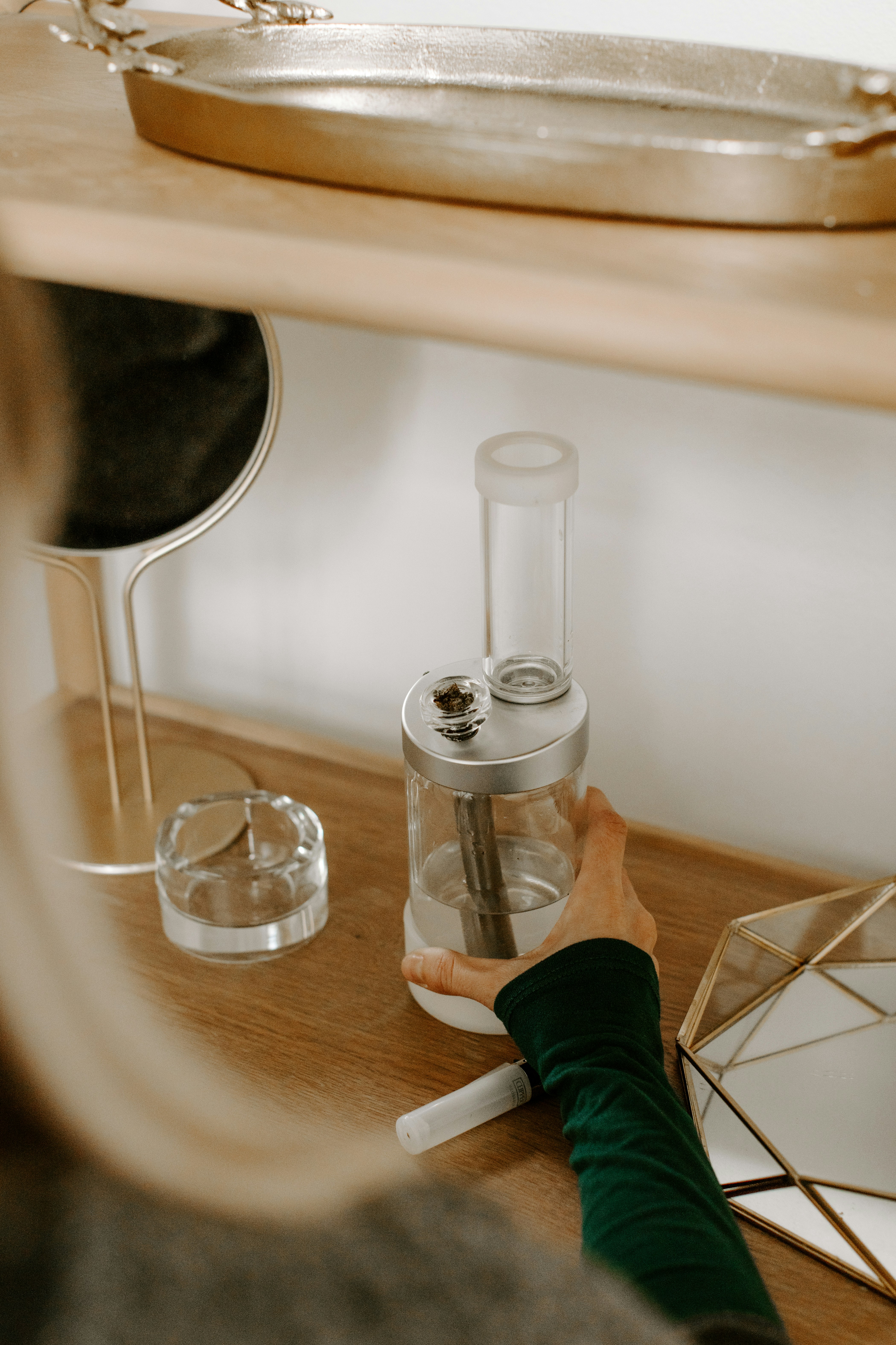 a person is holding a blender on a table