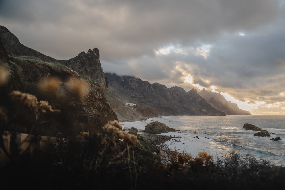 a view of the ocean with mountains in the background