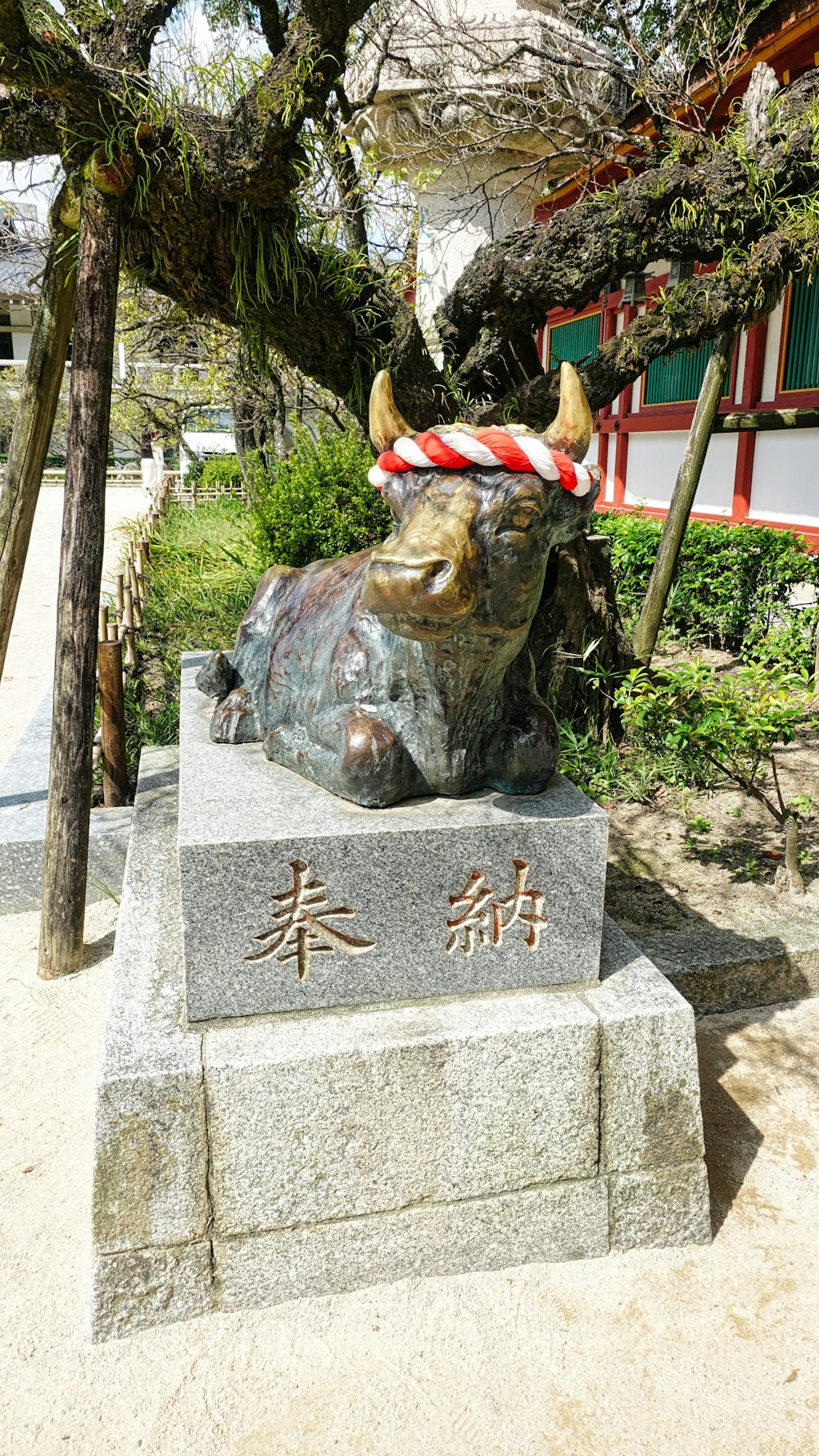a statue of a bull with a hat on its head