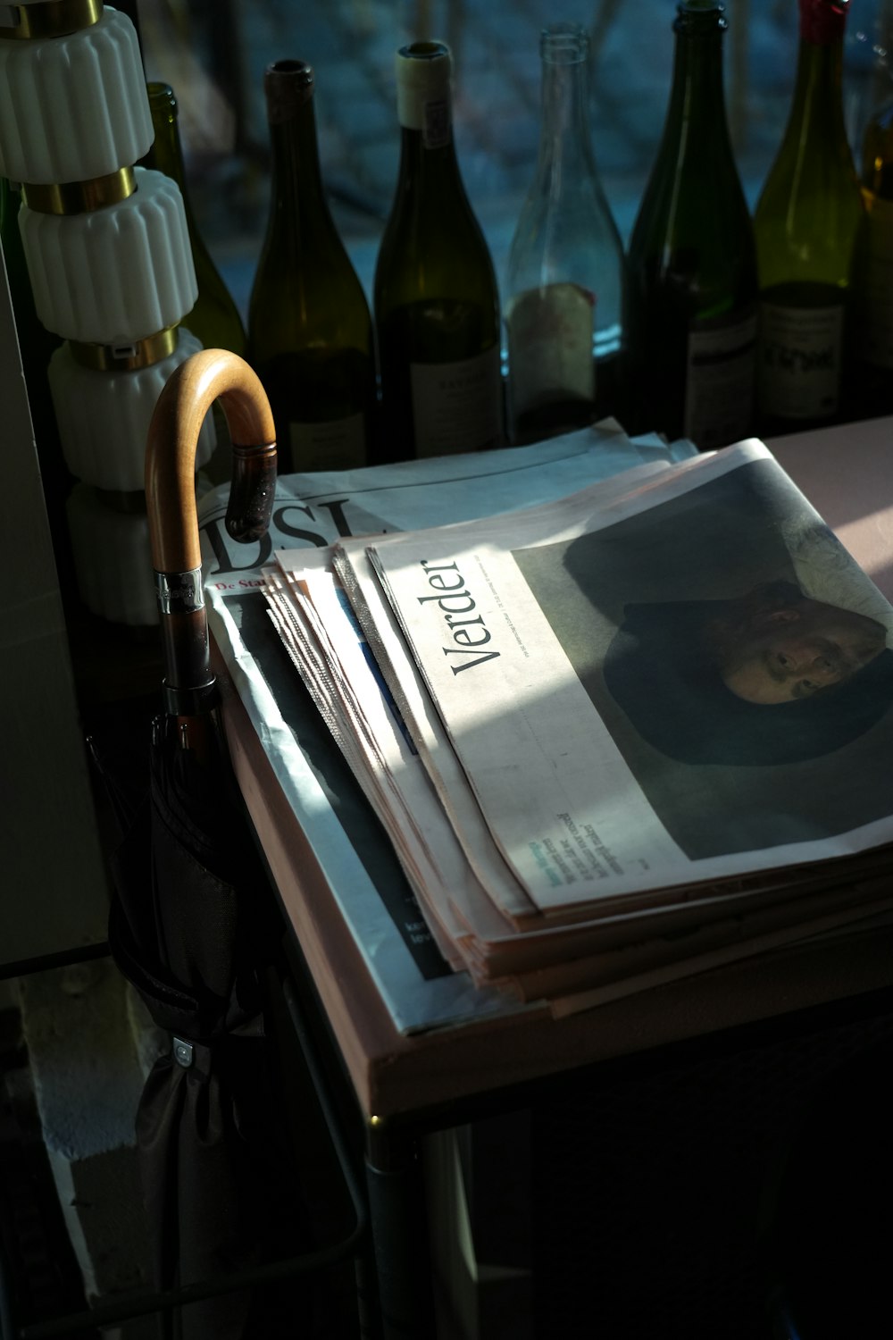 a stack of newspapers sitting on top of a table