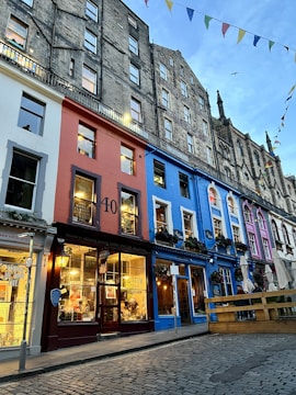 A neat row of freshly painted commercial storefronts in red, white, and blue tones.