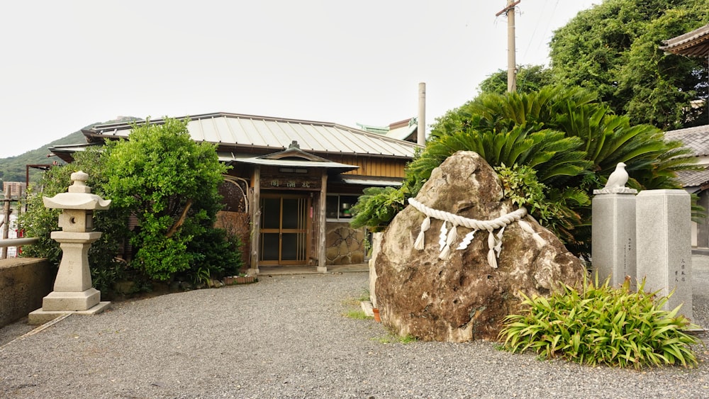 a large rock sitting in front of a building