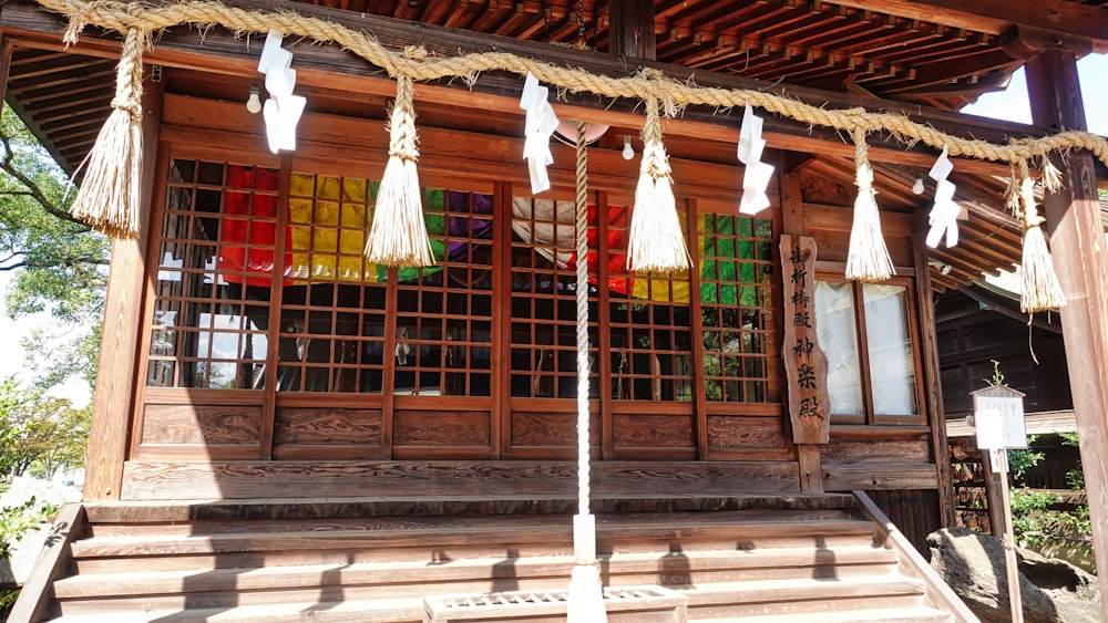 a wooden building with a bunch of tassels hanging from it's windows