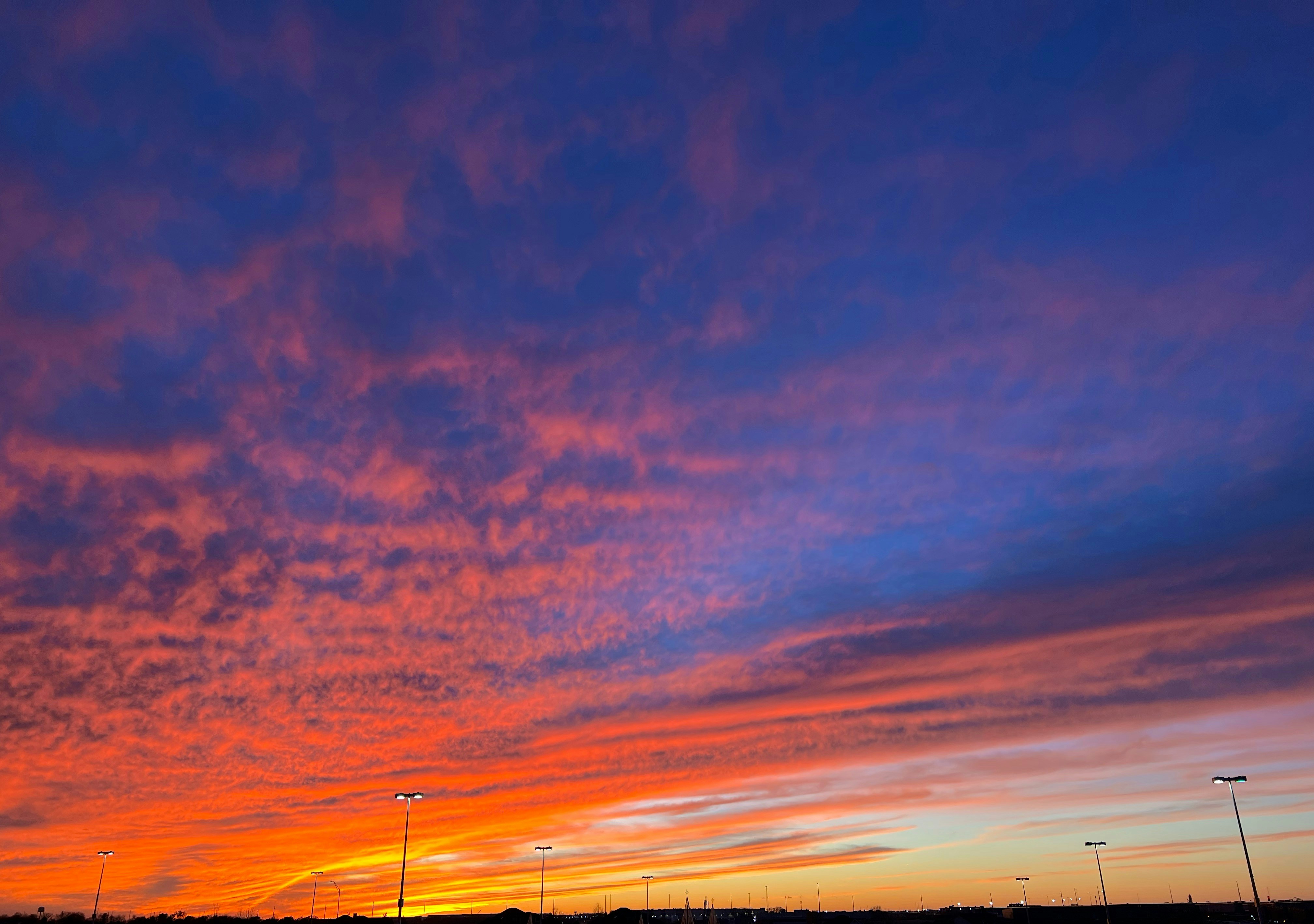 a red and blue sky with a few clouds