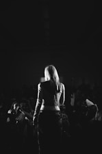 An old black-and-white photograph capturing Mark Sheridan performing on stage with a lively audience.