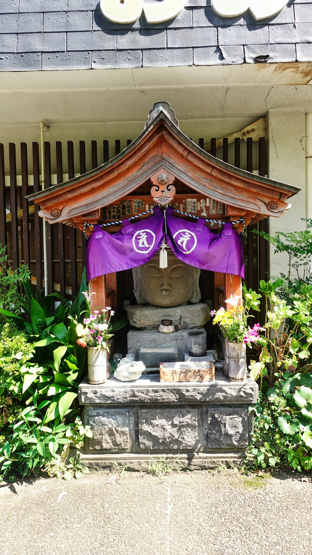 a statue of a buddha in front of a building