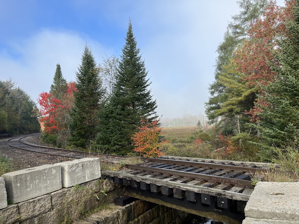 a train track crossing over a small bridge