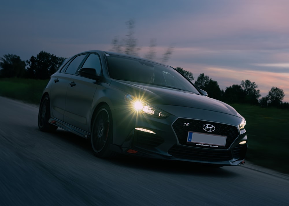 a car driving down a road at night