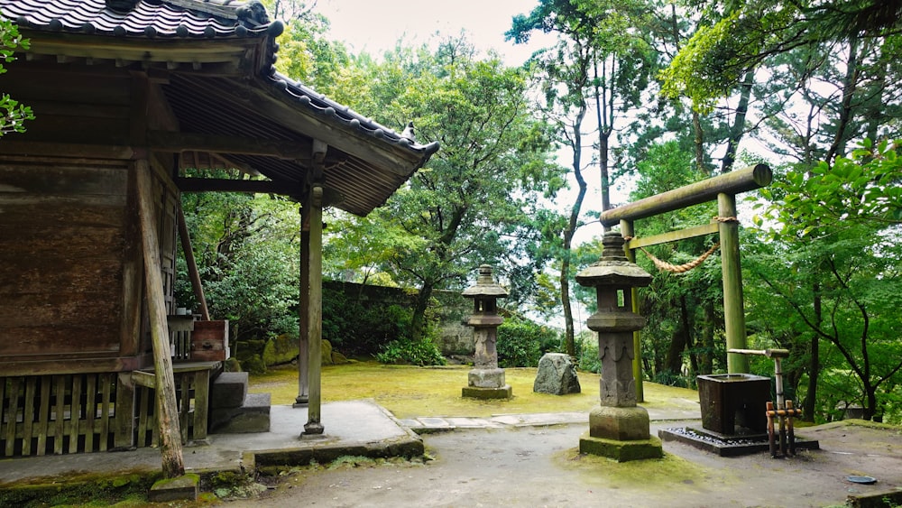 a small shrine in a park surrounded by trees