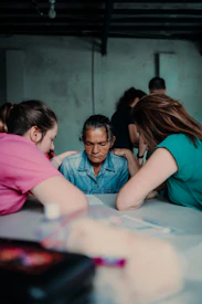 A cozy circle of people sharing stories in a grief support group.