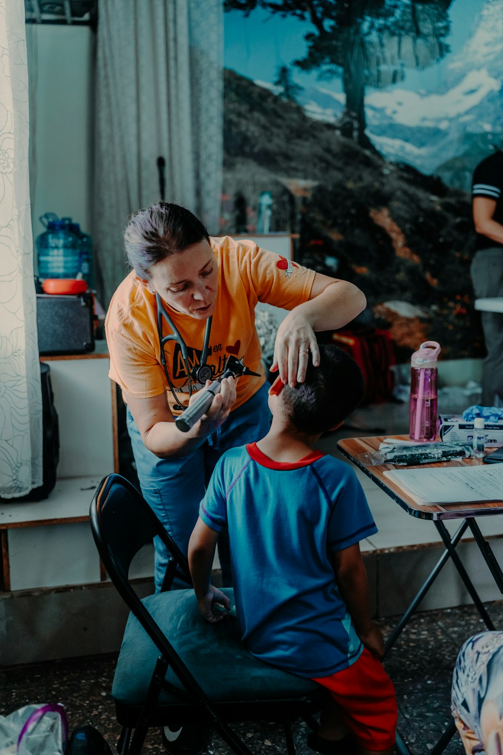 a woman is helping a boy with his hair
