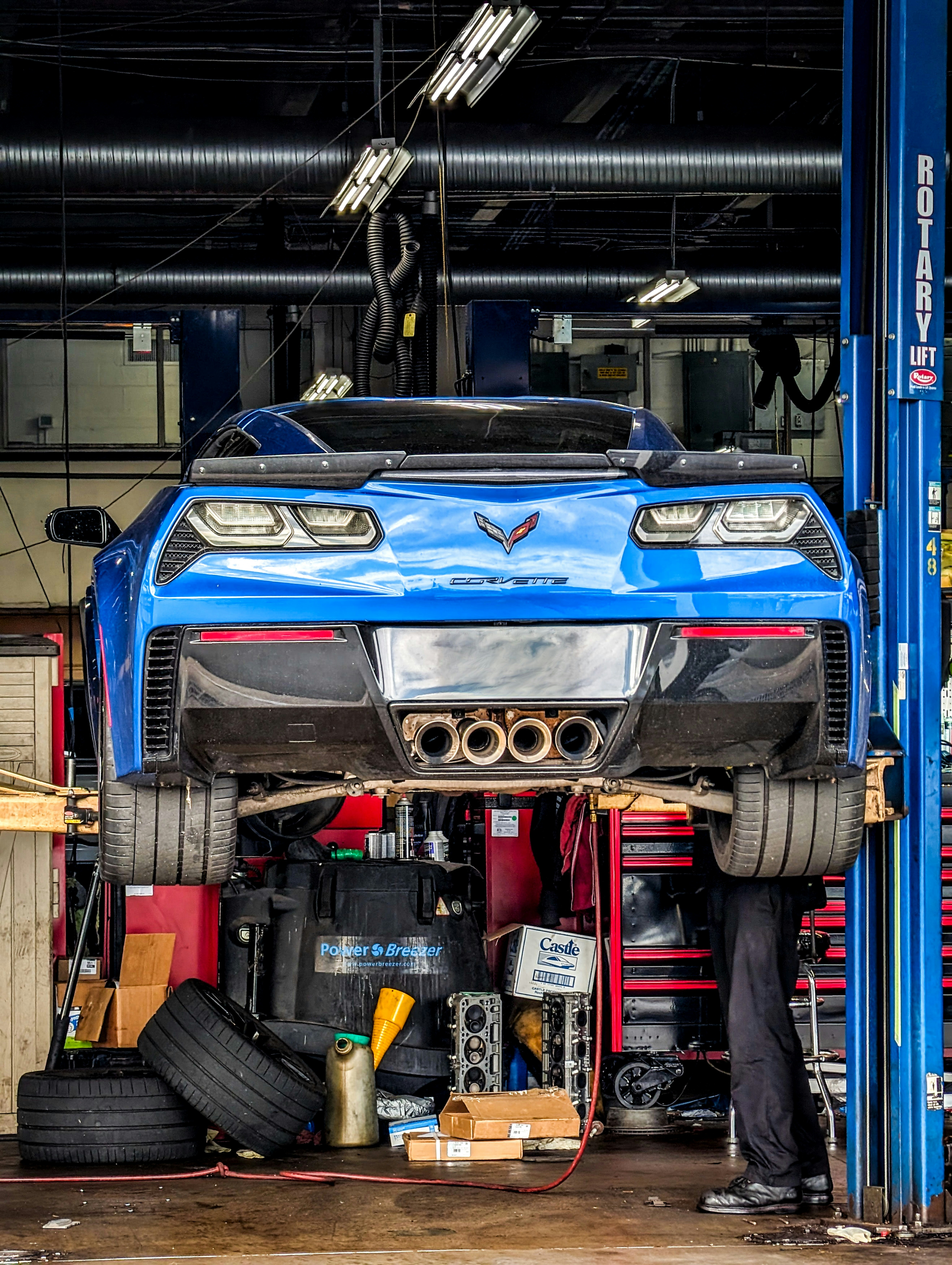 a man working on a car in a garage