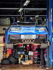 a man working on a car in a garage