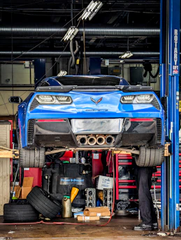 a man working on a car in a garage