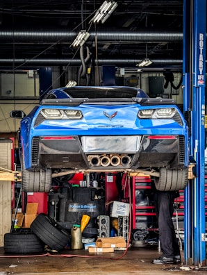a man working on a car in a garage