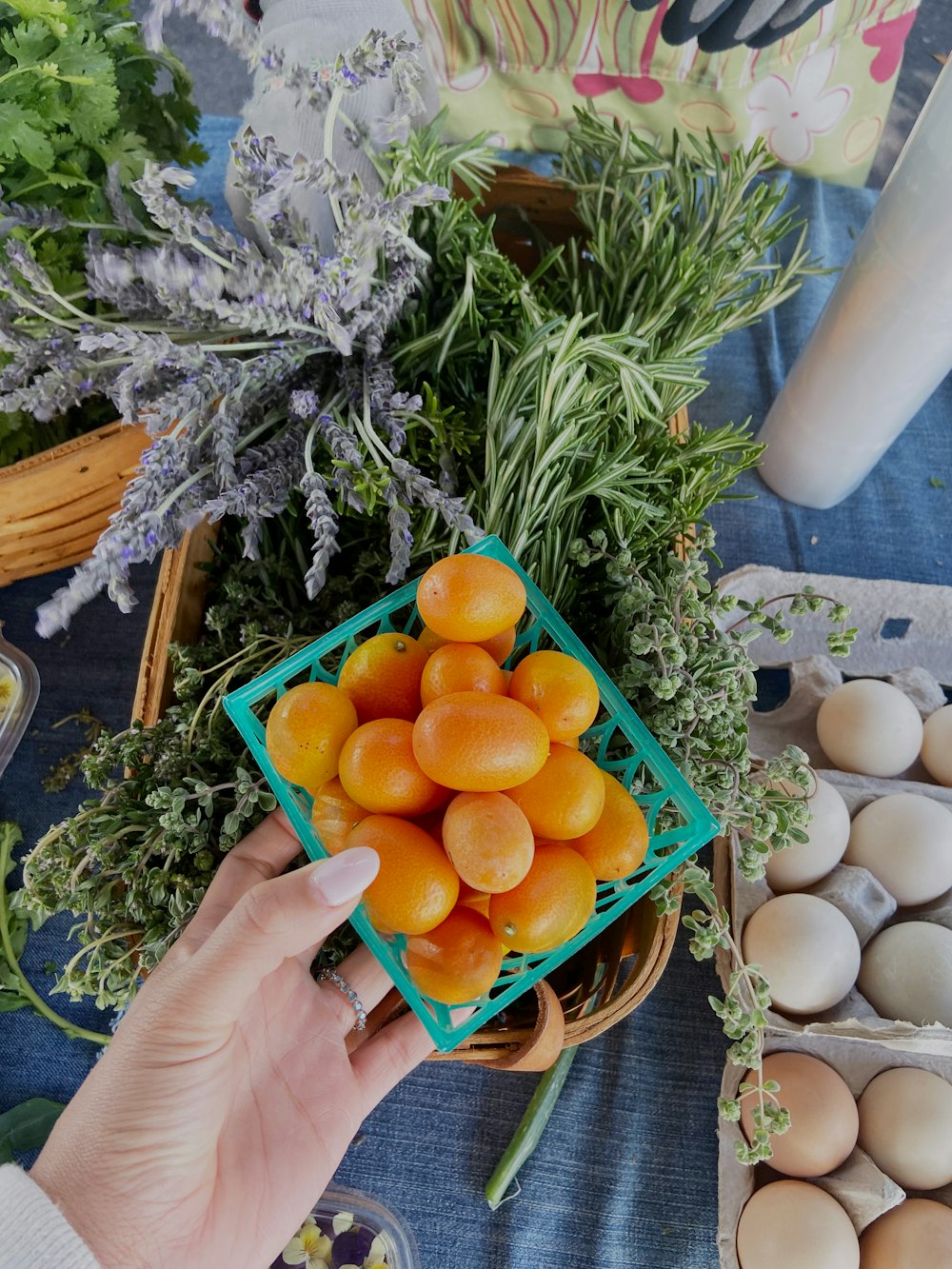 a person holding a basket full of oranges