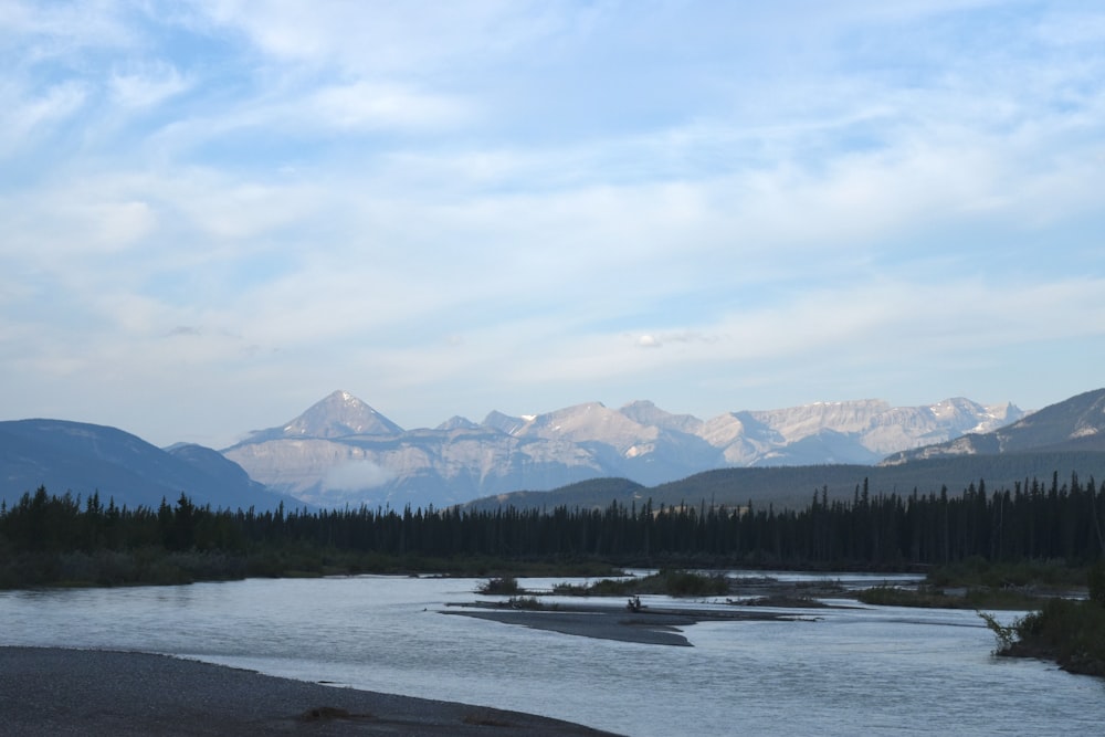 a river with mountains in the background