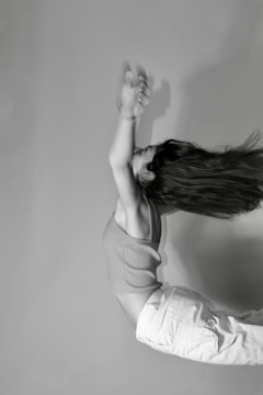A dramatic black and white portrait of an athlete in motion during a sports event.