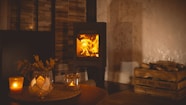 a fire burning in a wood stove in a living room