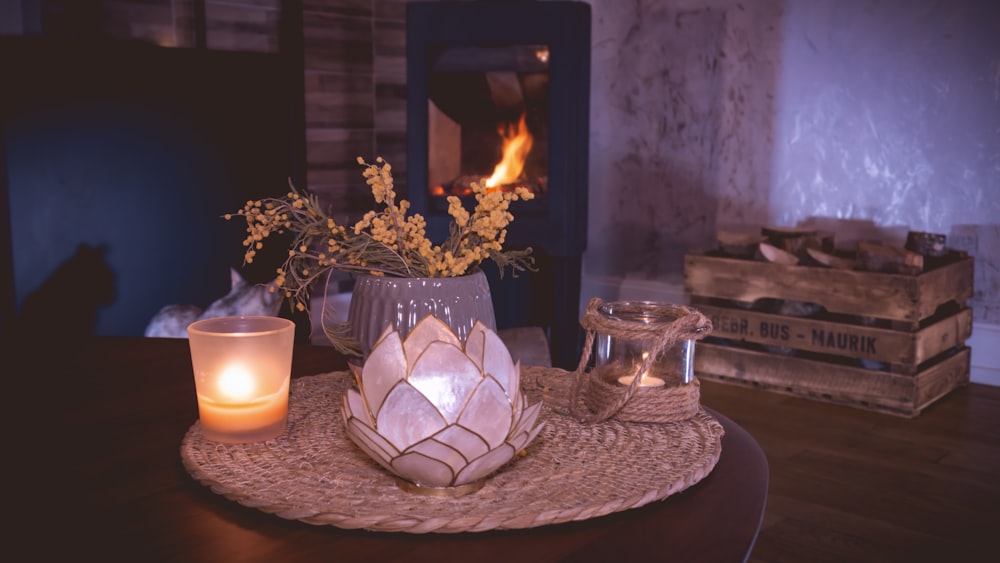 a table with a candle and a vase on it