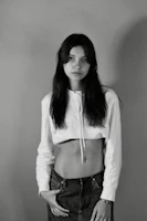 A model wearing a minimalist oversized hoodie in a neutral tone against a white background.