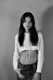 Model wearing a pale off-white oversized hoodie against a clean white backdrop