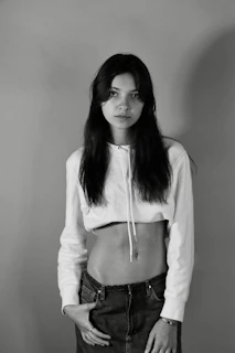 Lifestyle image of a model wearing a simple hoodie and pants against a plain background
