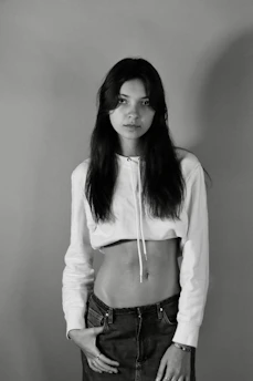 Model wearing a pale off-white oversized hoodie against a clean white backdrop