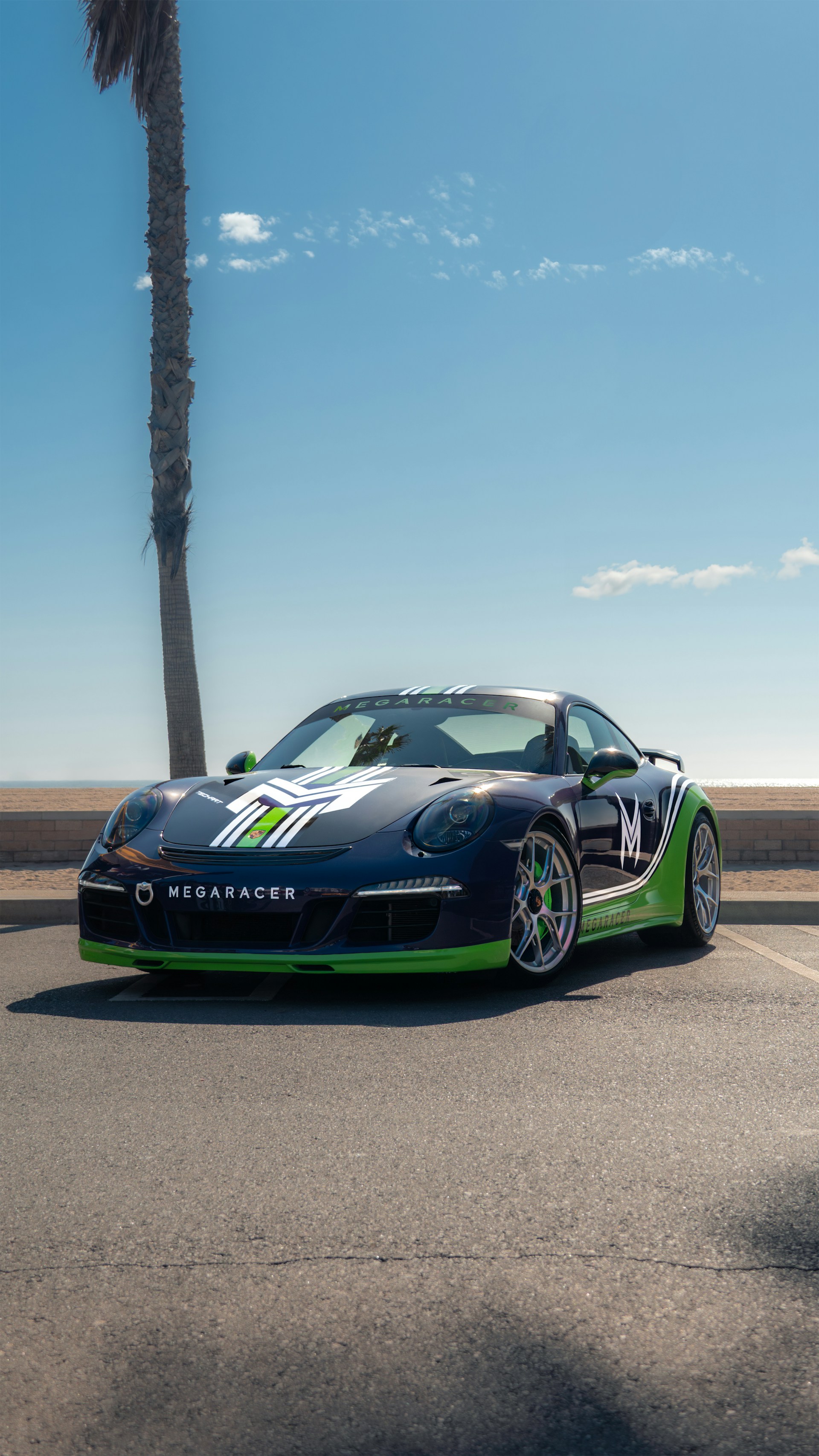A sleek Jaecoo Indonesia car model showcased on a coastal road with a teal sky background.