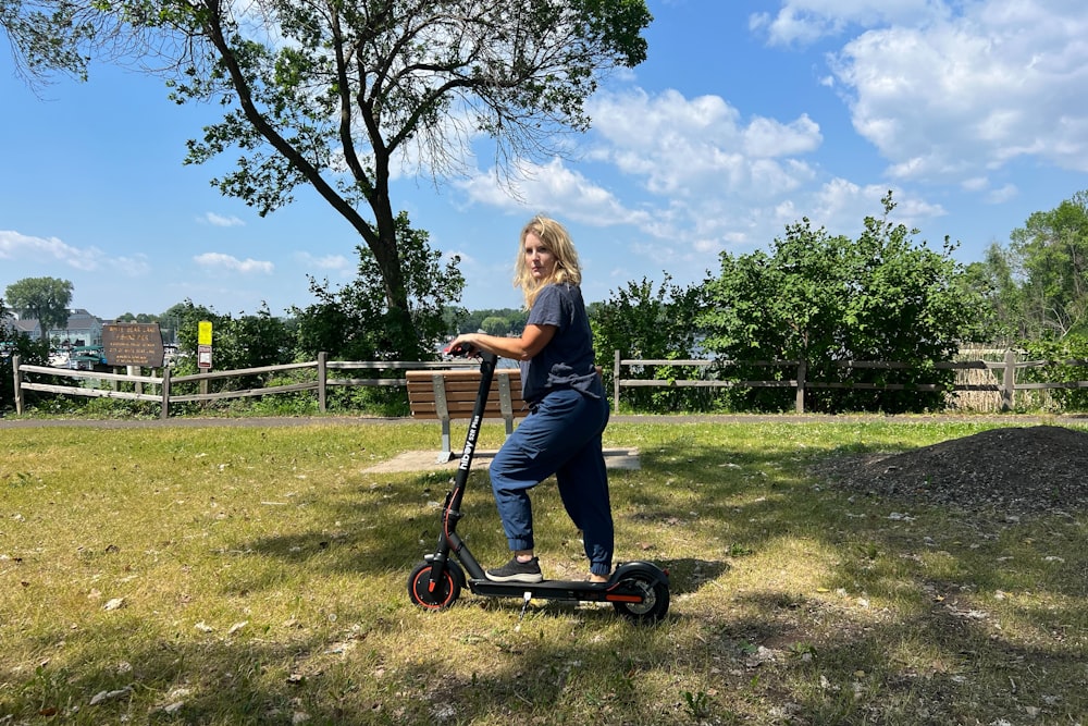 a woman riding an electric scooter in a park