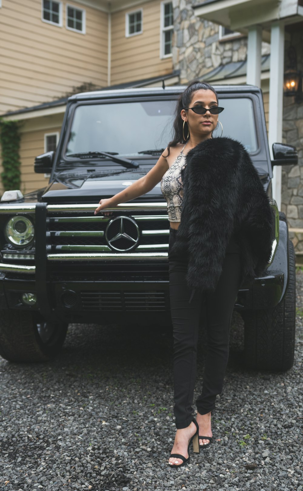 a woman standing in front of a mercedes benz benz benz benz benz benz benz benz