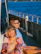 Happy couple relaxing at a cruise ship dining table with tropical backdrop.