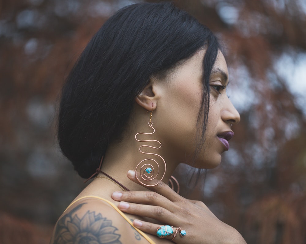 a woman with a tattoo on her shoulder