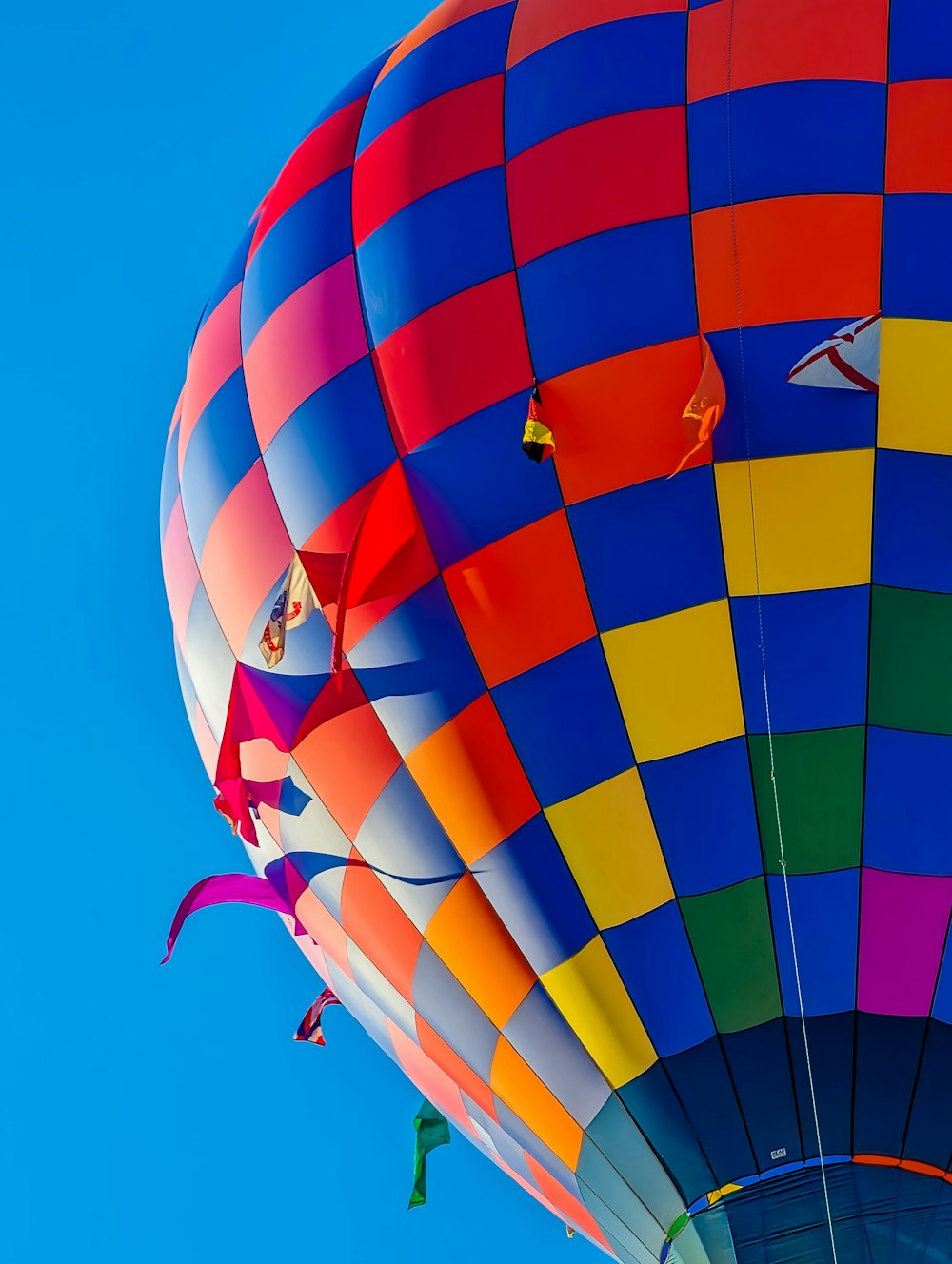 a colorful hot air balloon flying in a blue sky