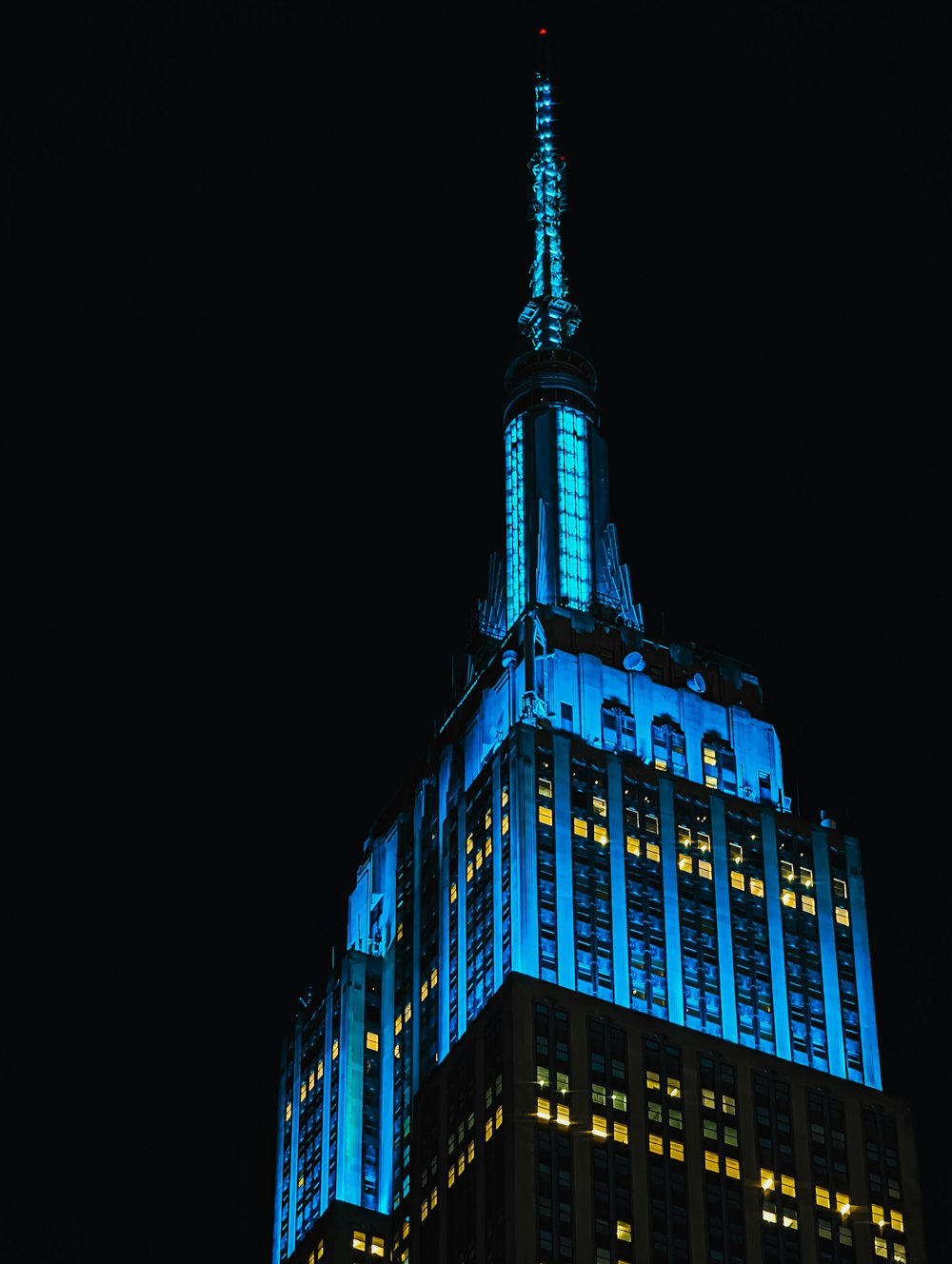 a very tall building lit up with blue lights