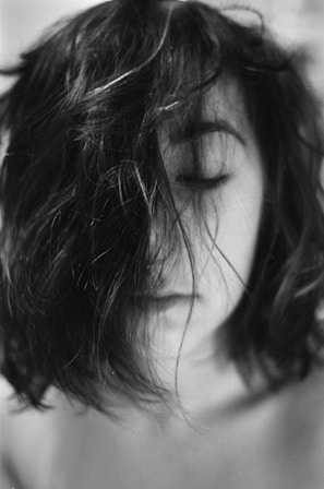 A moody black-and-white portrait of Echovibe lost in music with eyes closed